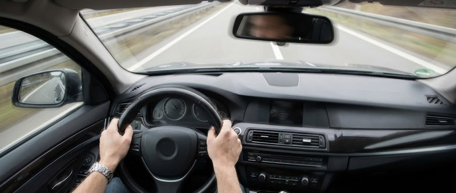 Lenkrad zittert ab 100 km/h - Fahrersicht im Auto auf der Autobahn: Hände umklammern das vibrierende Lenkrad, oft verursacht durch eine Unwucht der Reifen ab 100 km/h.